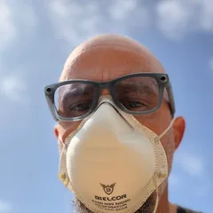 The artist in a respirator mask, mid-session